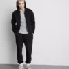 Elastické tepláky s manžetami