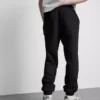 Elastické tepláky s manžetami