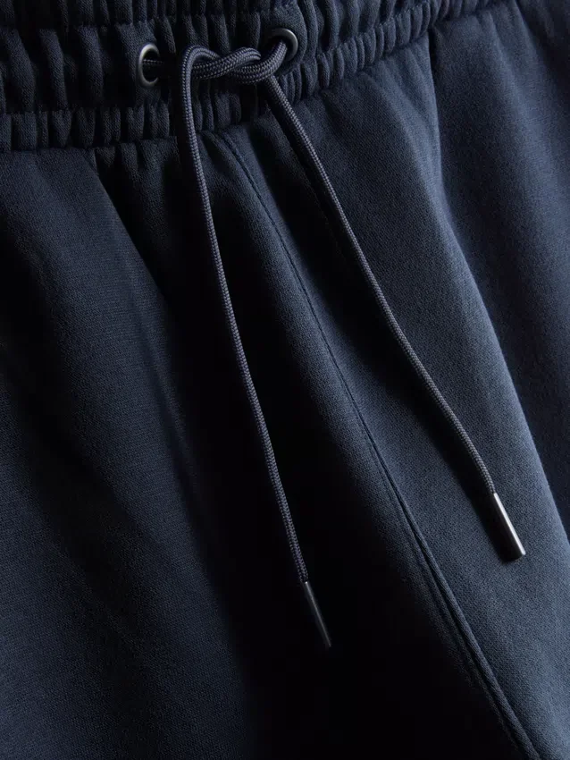 Elastické tepláky s manžetami