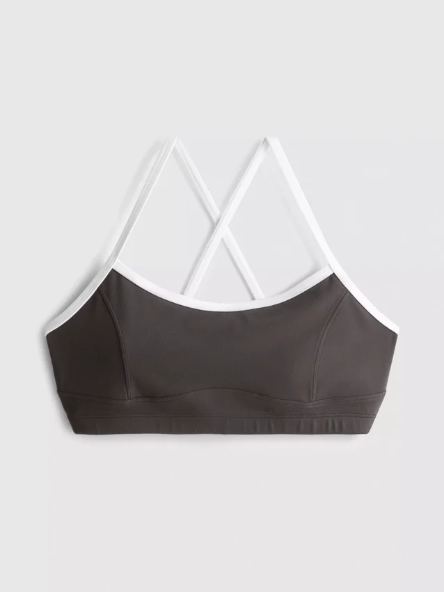 Kontrastně lemovaný sportovní crop top s kříženými ramínky na zádech